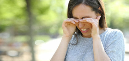 Photo of a woman rubbing her eyes