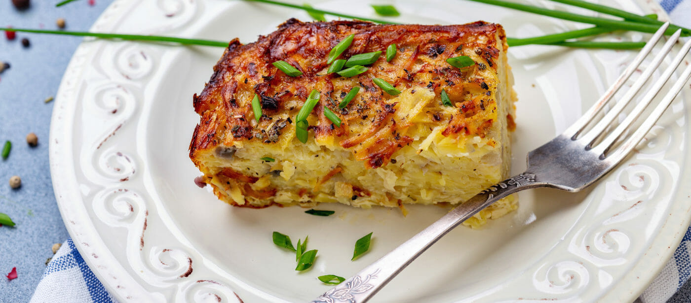 Piece of potato kugel on a plate.