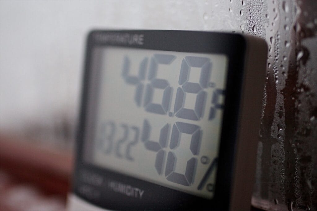 Digital hygrometer showing optimal indoor humidity levels for allergy control